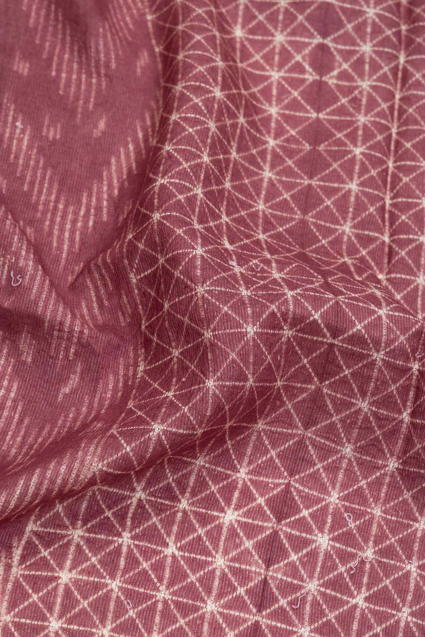 Close up of Brown Dual Tone Tussar Saree with Printed design on the body and Zari Border.  displaying folds