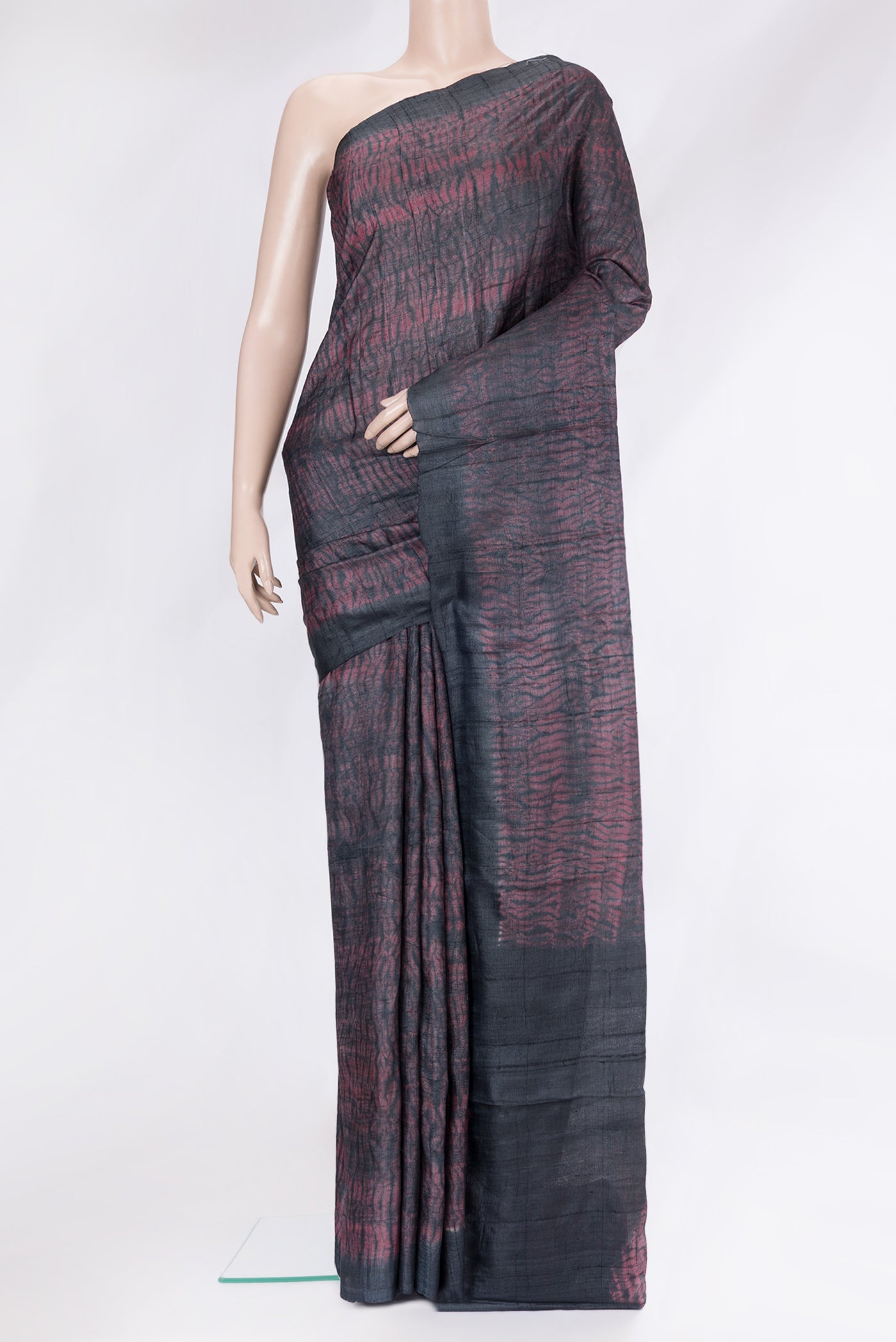 Maroon Dual Tone Tussar Silk Saree with Printed design on the body and Plain Border.  displayed on a mannequin