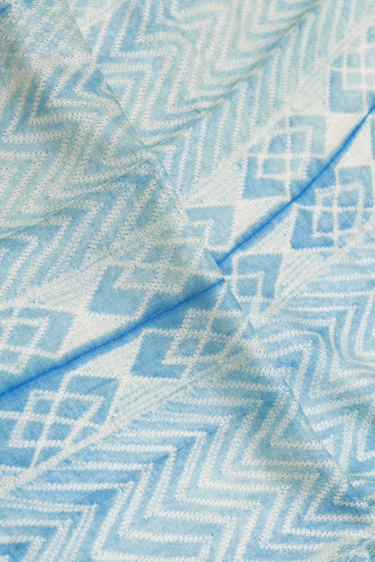 Close up of Royal Blue Dual Tone Tussar Silk SareePrinted design on the body and Zari Border displaying folds