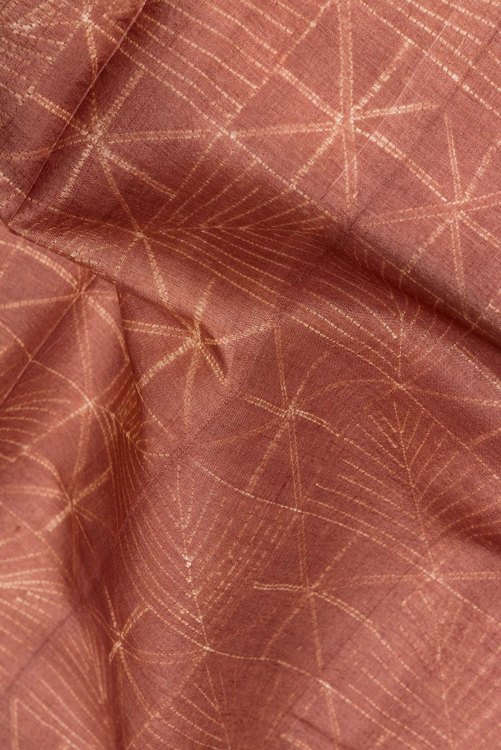Close up of Brown Dual Tone Georgette Saree with Printed design on the body and Fancy Border.  displaying folds