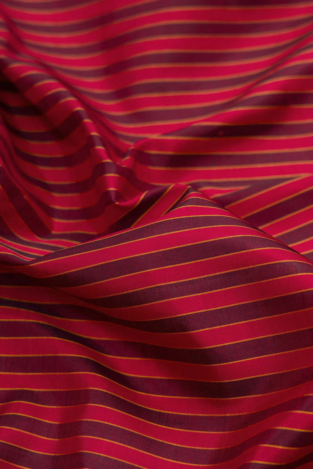 Close up of Maroon Dual Tone Kanchipuram Silk Saree with Stripes on the body and Thread Border displaying folds