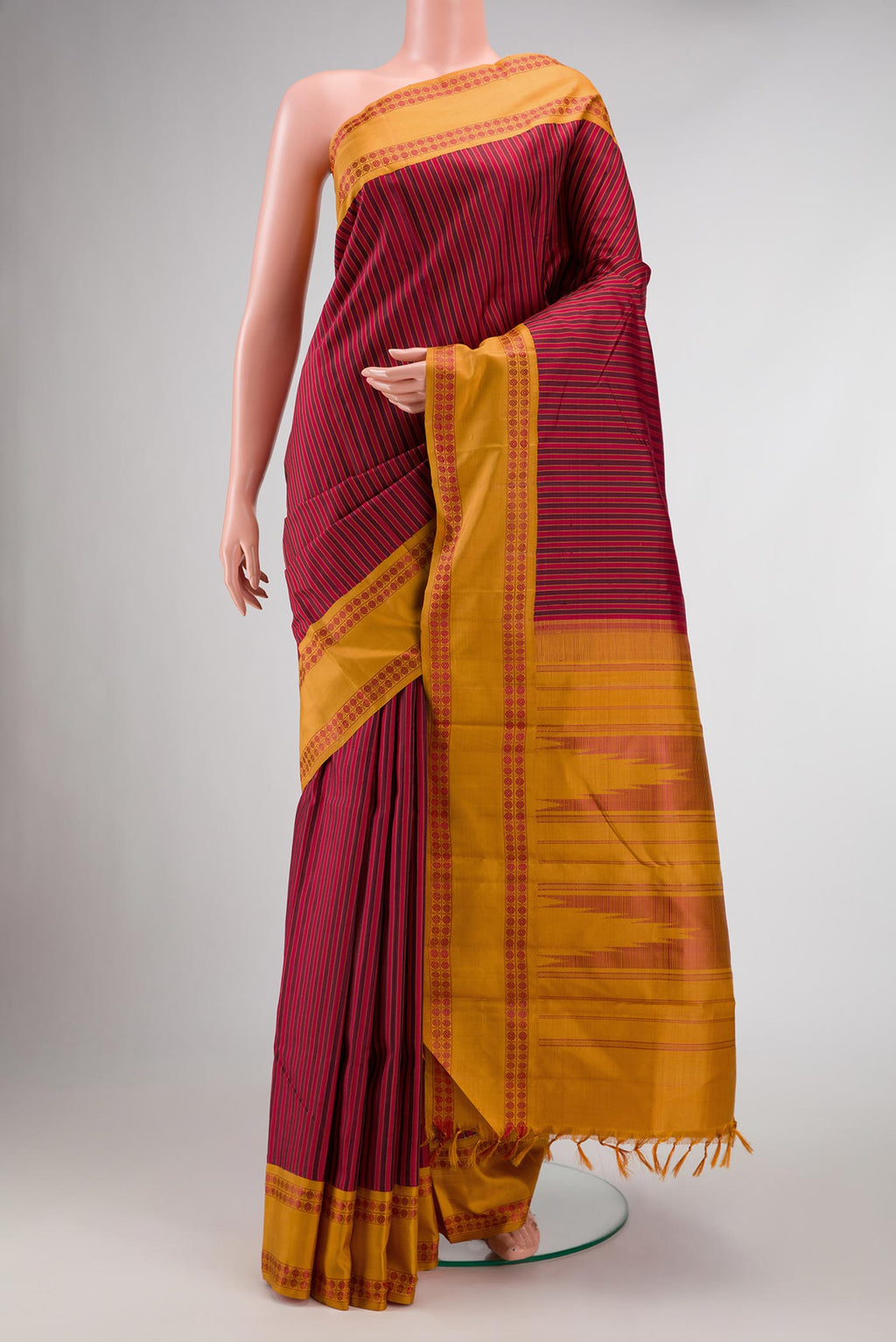 Maroon Dual Tone Kanchipuram Silk Saree with Stripes on the body and Thread Border displayed on a mannequin