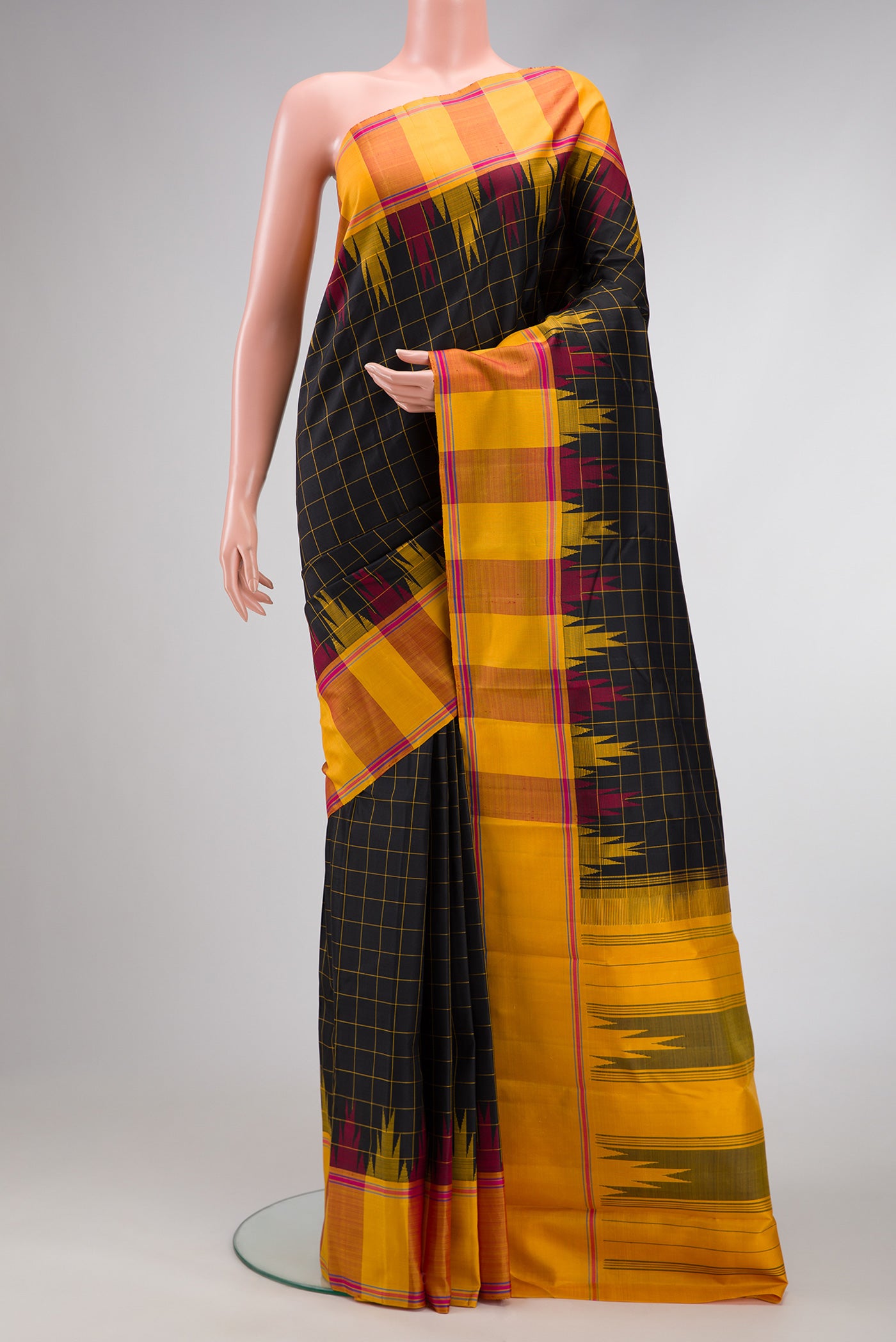 Black Dual Tone Kanchipuram Silk Saree with Checked design on the body and Temple Border.  displayed on a mannequin