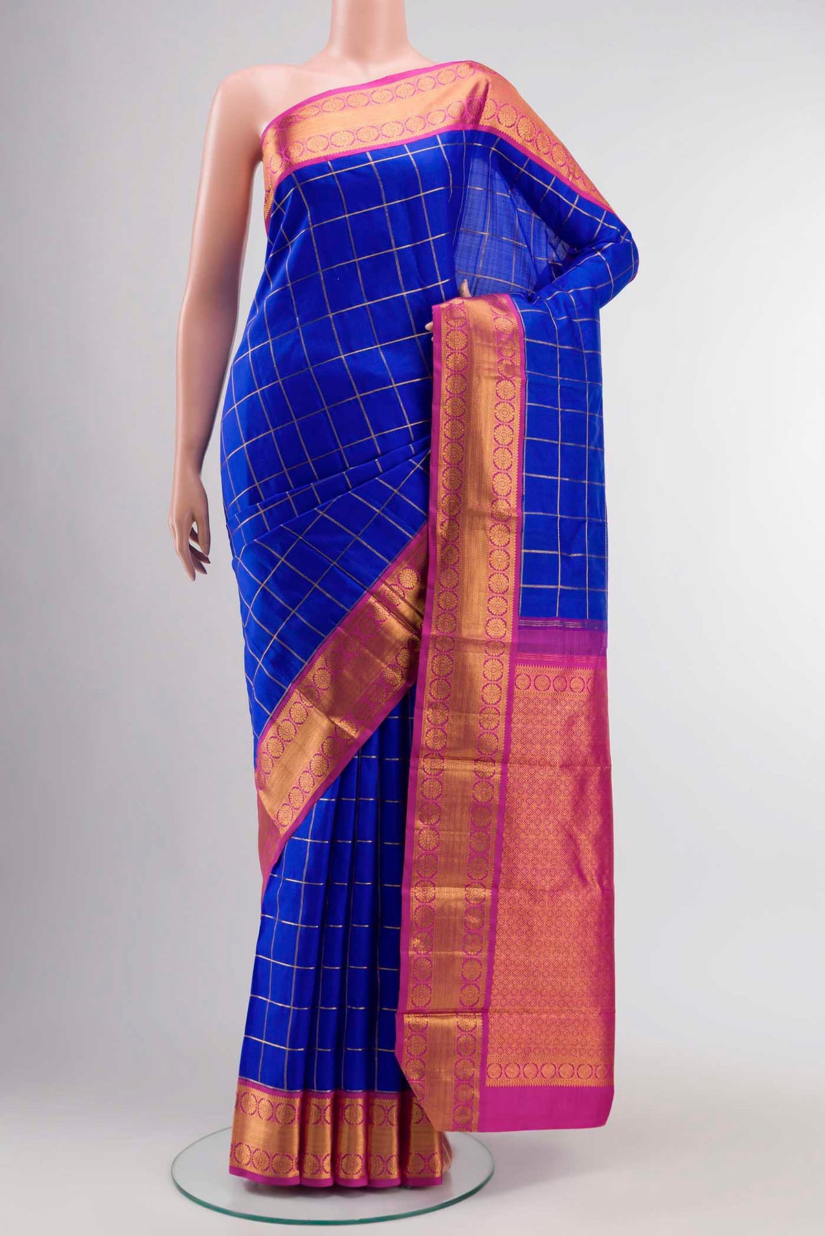 Blue Kanchipuram Silk Saree with Checked design on the body and Zari Border displayed on a mannequin