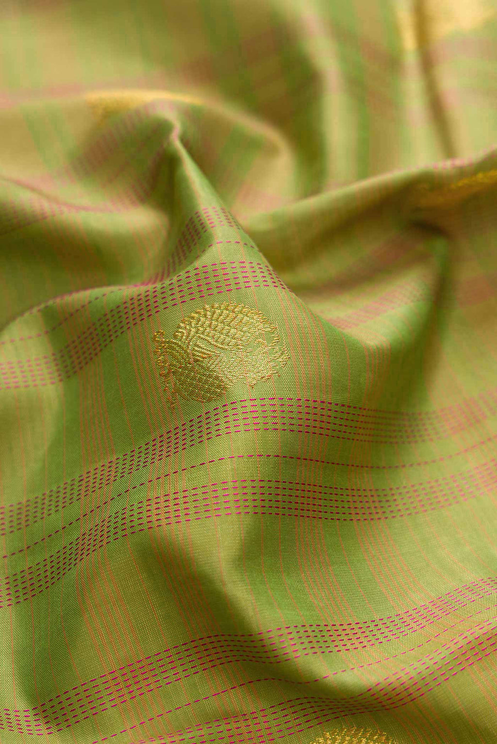 Close up of Pure Silk Pure Zari Green Dual Tone Kanchipuram Saree with Zari Butta on the body and Zari Border displaying folds