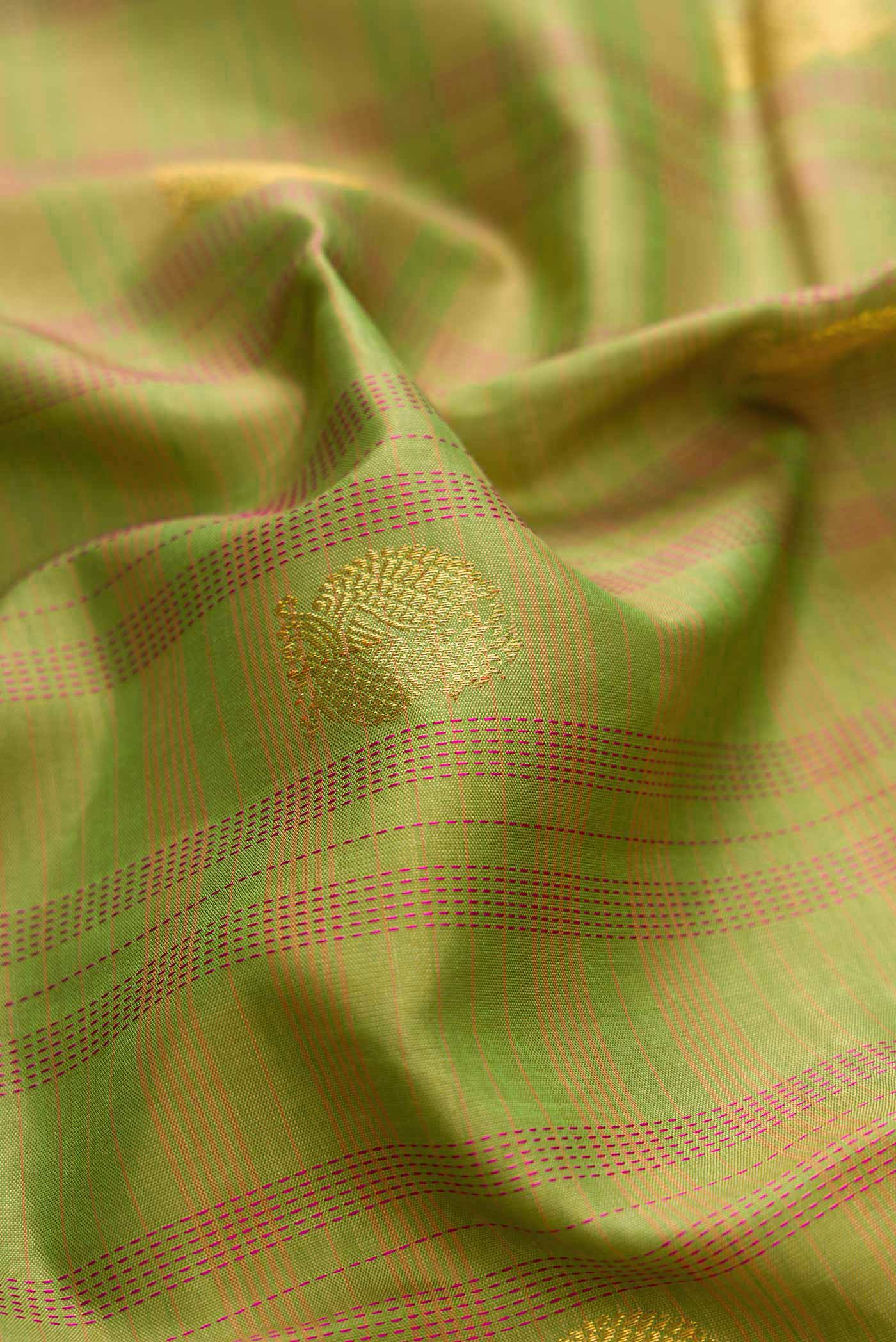 Close up of Pure Silk Pure Zari Green Dual Tone Kanchipuram Saree with Zari Butta on the body and Zari Border displaying folds