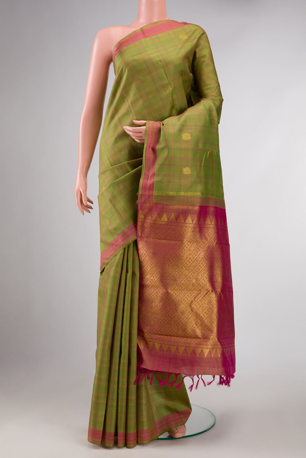 Pure Silk Pure Zari Green Dual Tone Kanchipuram Saree with Zari Butta on the body and Zari Border displayed on a mannequin