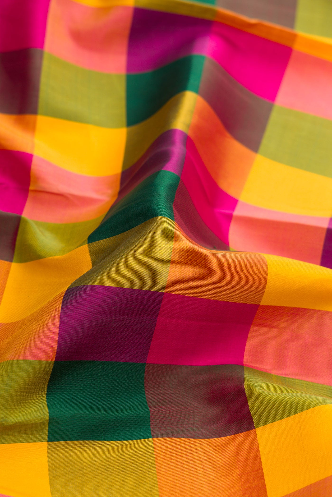 Close up of Multi Color Kanjivaram Silk Saree with Checked design on the body and Zari Border.  displaying folds