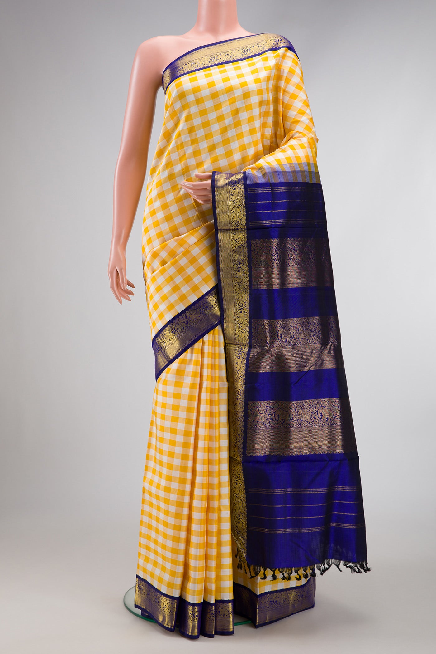 Pure Silk Pure Zari Off White and Musturd Color Kanchipuram Nine Yards Saree with Checked design on the body and Zari Border.  displayed on a mannequin