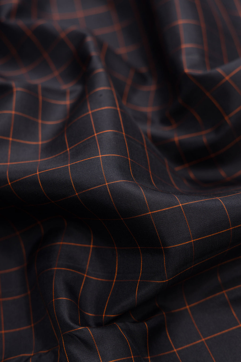 Close up of Black Dual Tone Kanjivaram Silk Saree with Checked design on the body and Zari Border.  displaying folds