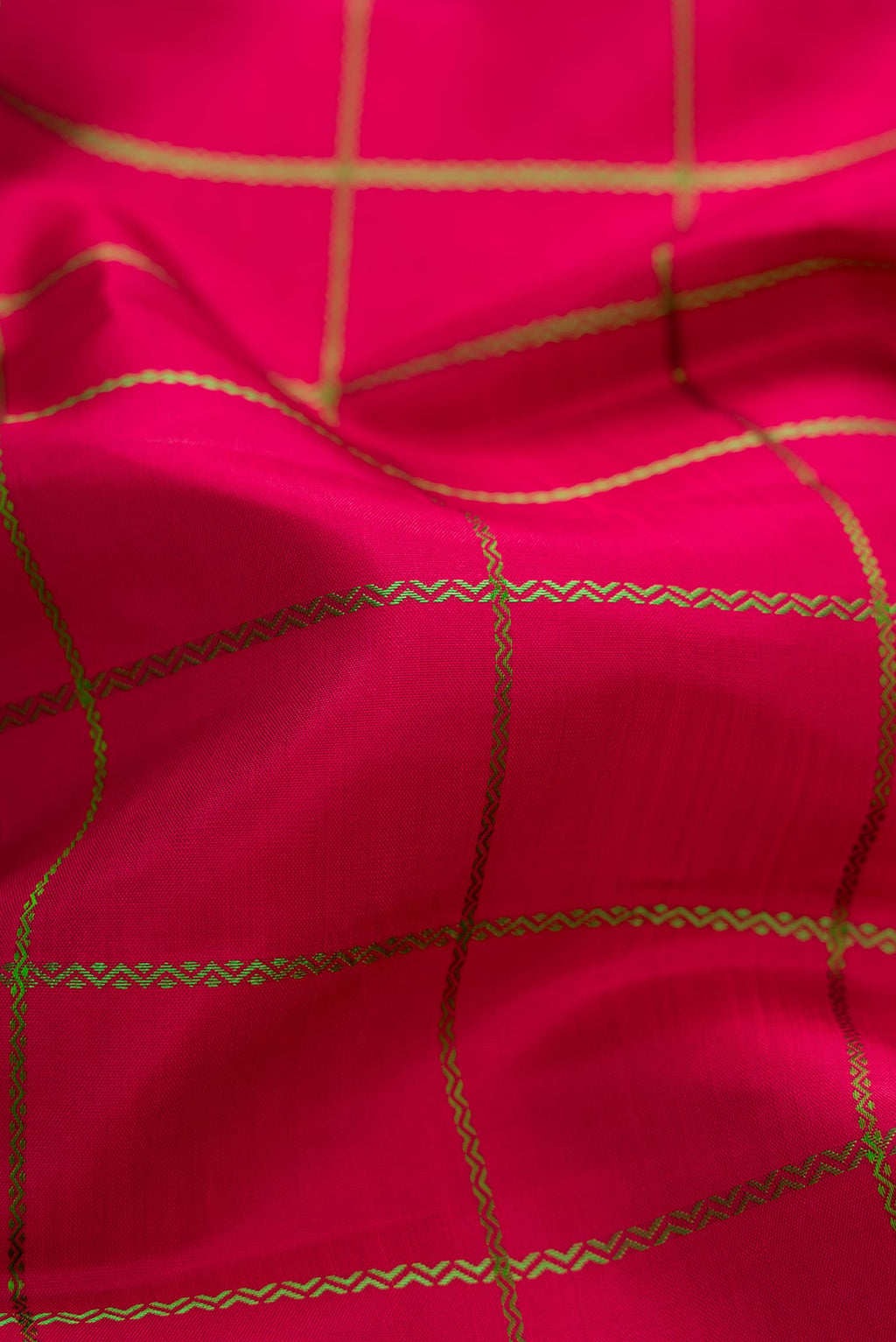 Close up of Maroon Dual Tone Kanchipuram Silk Saree with Checked design on the body and Zari Border displaying folds
