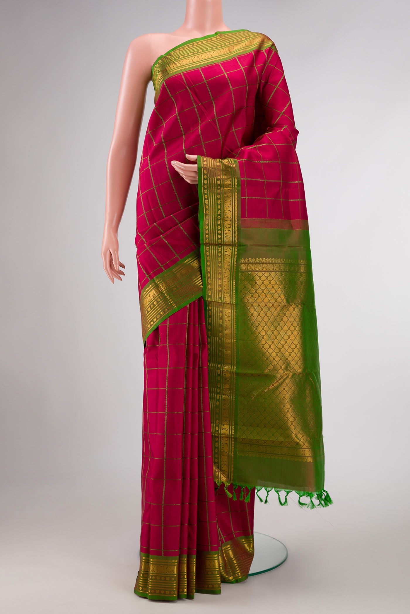 Maroon Dual Tone Kanchipuram Silk Saree with Checked design on the body and Zari Border displayed on a mannequin