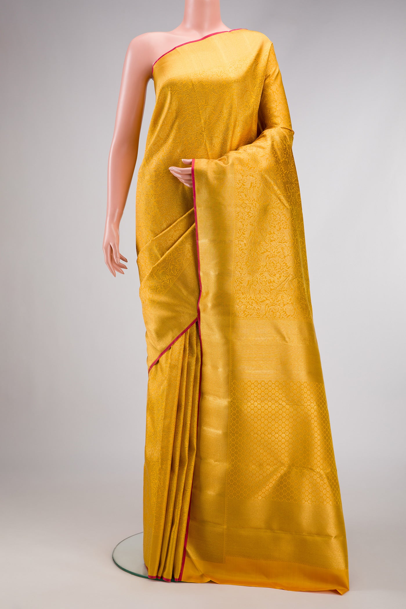Pure Silk Pure Zari Gold Dual Tone Kanjivaram Saree with Zari Brocade on the body and Zari Border.  displayed on a mannequin