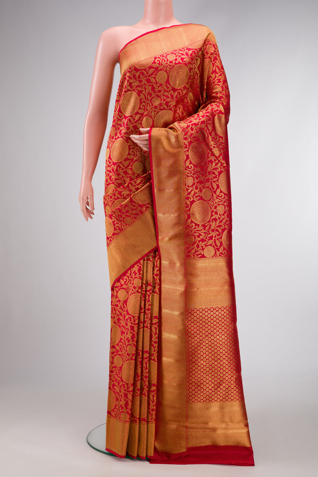 Pure Silk Pure Zari Red Dual Tone Kanjivaram Saree with Zari Brocade on the body and Zari Border.  displayed on a mannequin