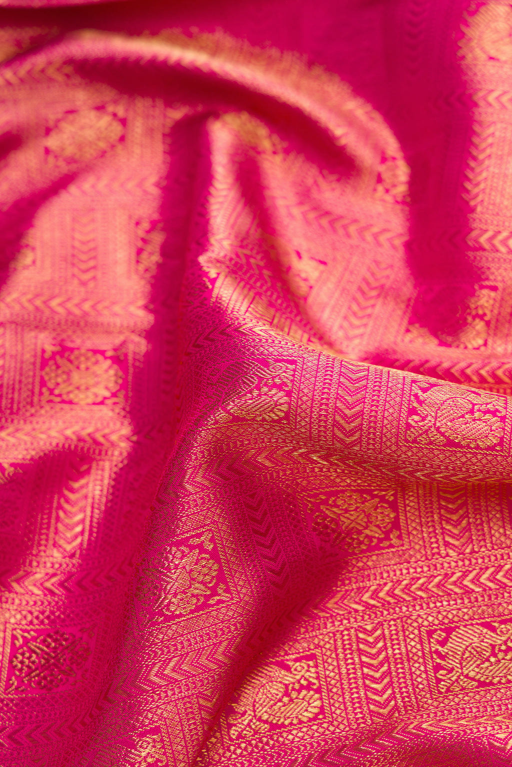 Close up of Pure Silk Pure Zari Pink Dual Tone Kanjivaram Saree with Zari Brocade on the body and Zari Border.  displaying folds