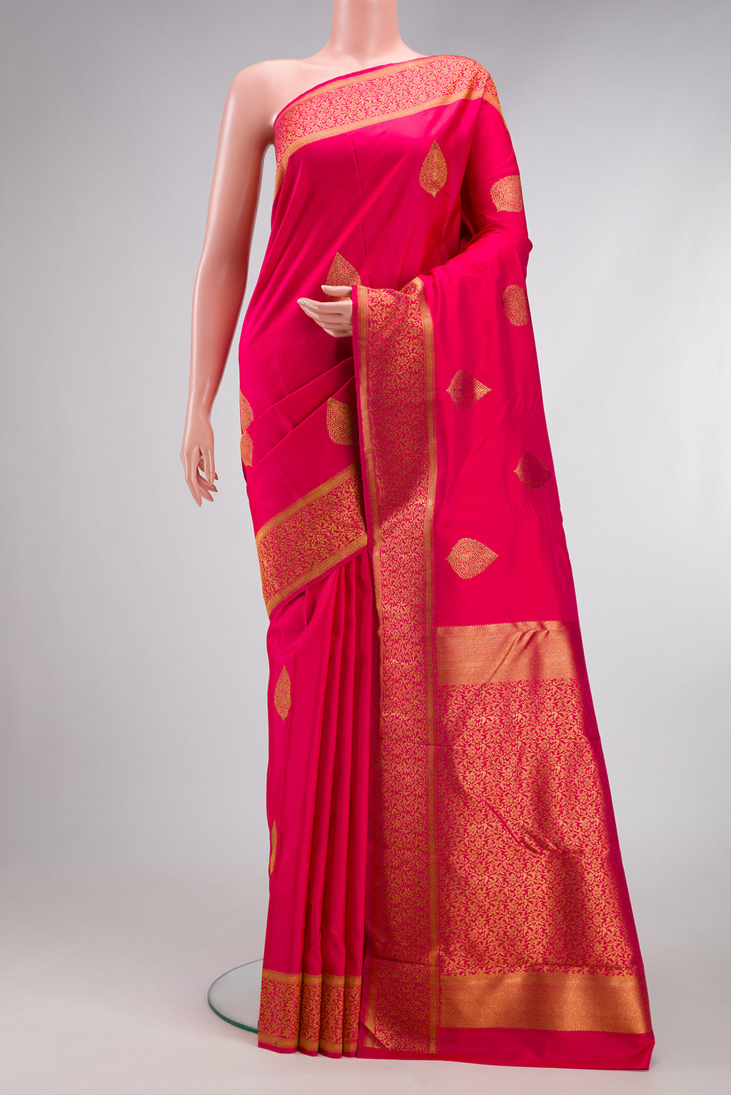 Pure Silk Pure Zari Pink Kanjivaram Saree with Zari Butta on the body and Zari Border.  displayed on a mannequin