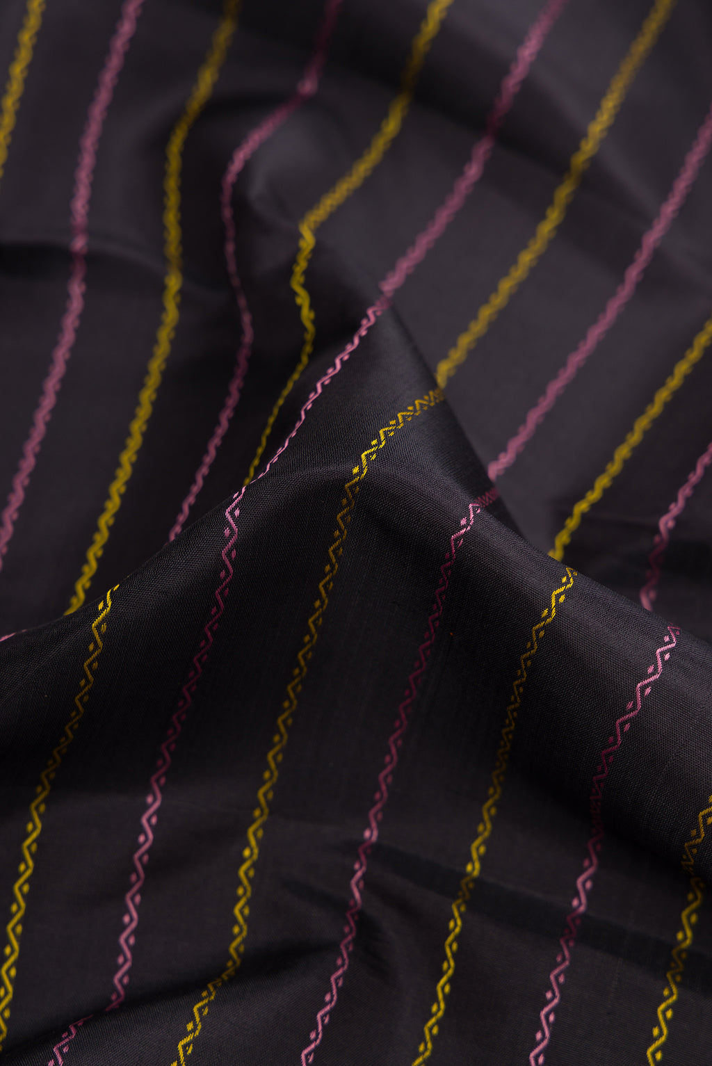 Close up of Pure Silk Pure Zari Black Dual Tone Kanjivaram Saree with Veldhari on the body and Zari Border.  displaying folds