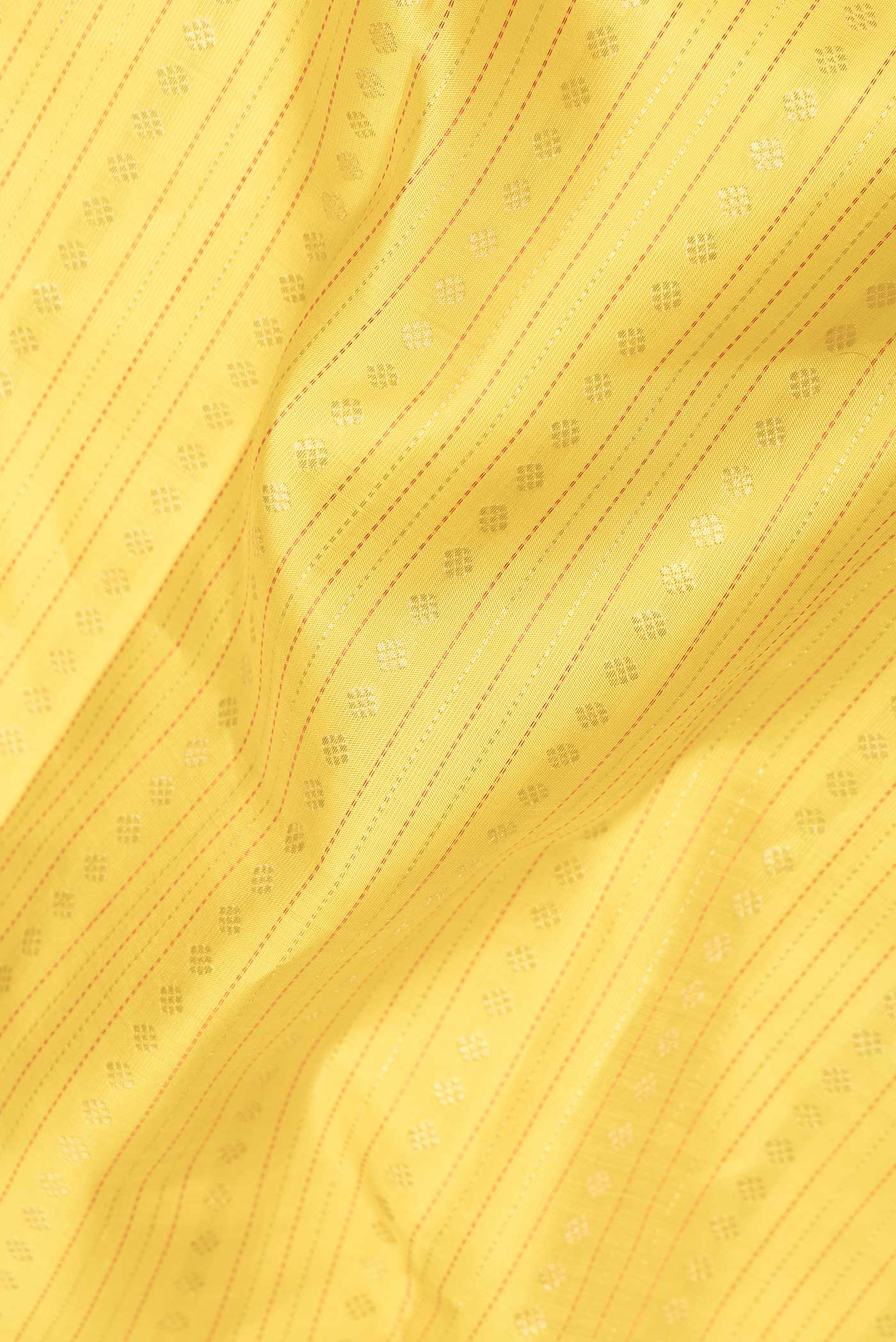 Close up of Pure Silk Pure Zari Yellow Dual Tone Kanchipuram Saree with Zari Brocade on the body and Zari Border displaying folds