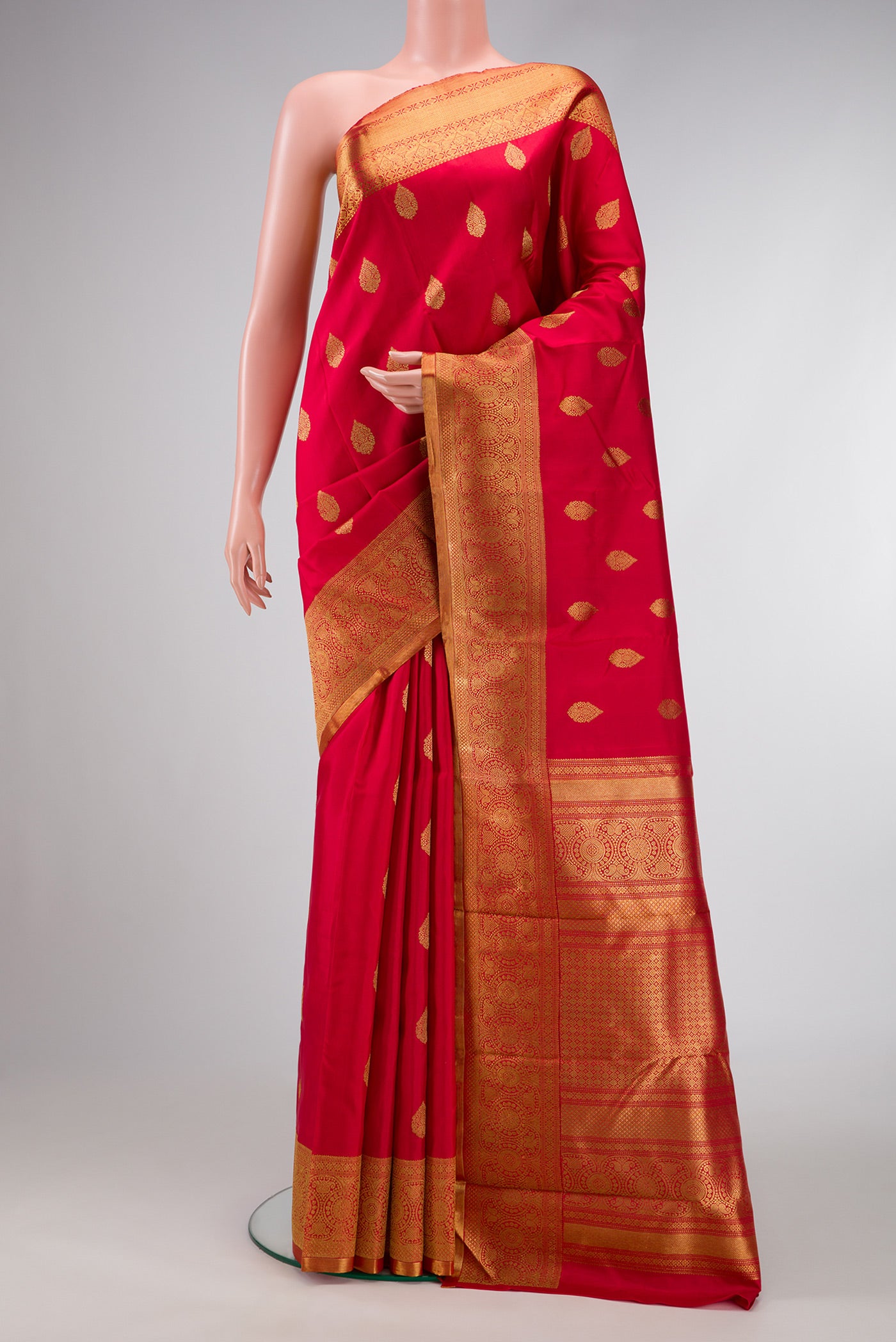 Pure Silk Pure Zari Red Dual Tone Kanjivaram Saree with Zari Butta on the body and Zari Border.  displayed on a mannequin