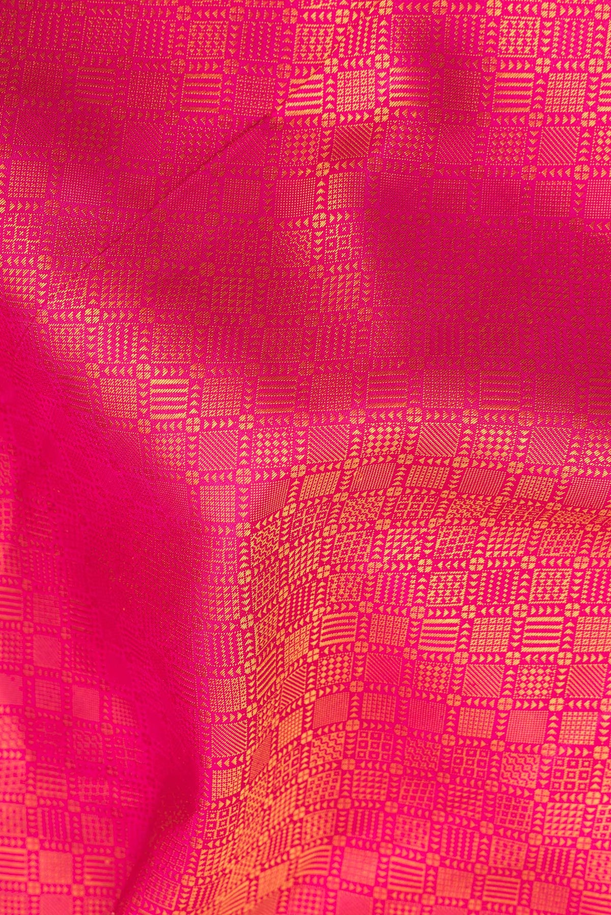 Close up of Pure Silk Pure Zari Pink Kanjivaram Saree with Jacquard design on the body and Fancy Border.  displaying folds