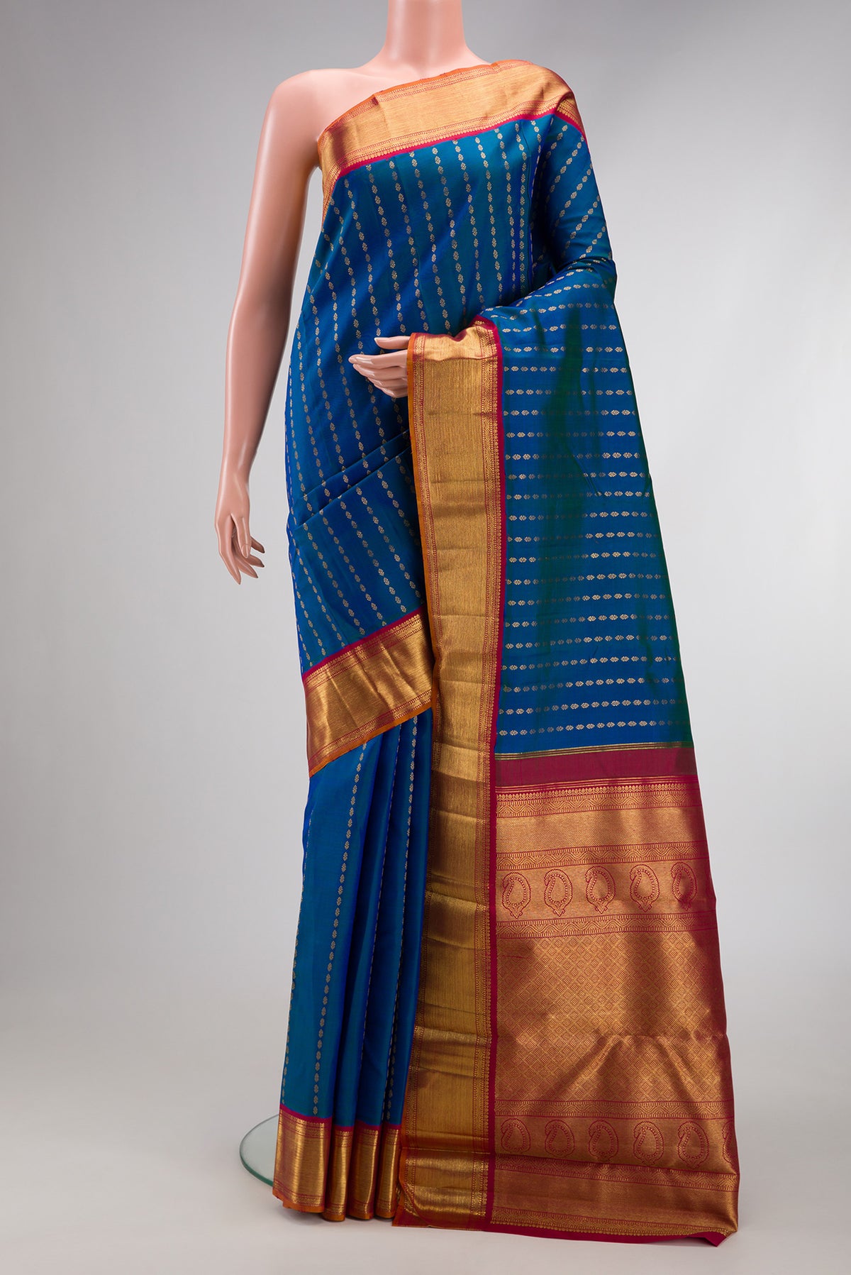 Pure Silk Pure Zari Peacock Blue Dual Tone Kanjivaram Saree with Zari Butta on the body and Zari Border.  displayed on a mannequin