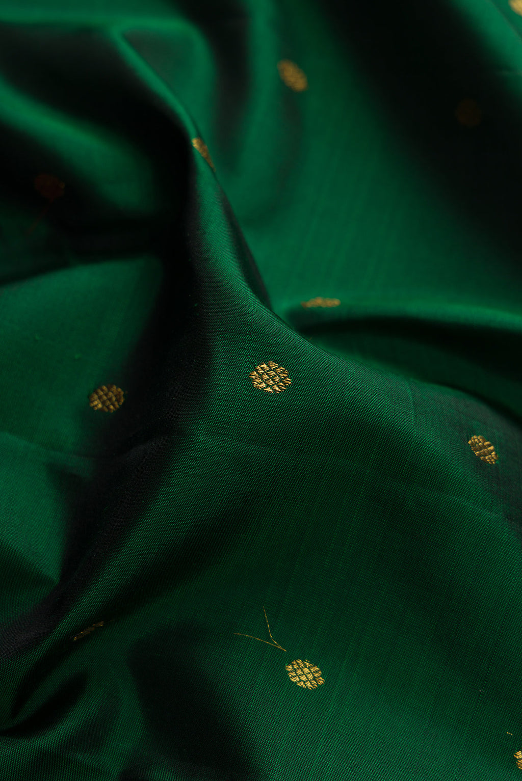 Close up of Pure Silk Pure Zari Bottle Green Kanjivaram Saree with Zari Butta on the body and Zari Border.  displaying folds