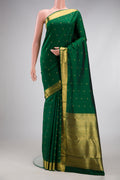 Pure Silk Pure Zari Bottle Green Kanjivaram Saree with Zari Butta on the body and Zari Border.  displayed on a mannequin