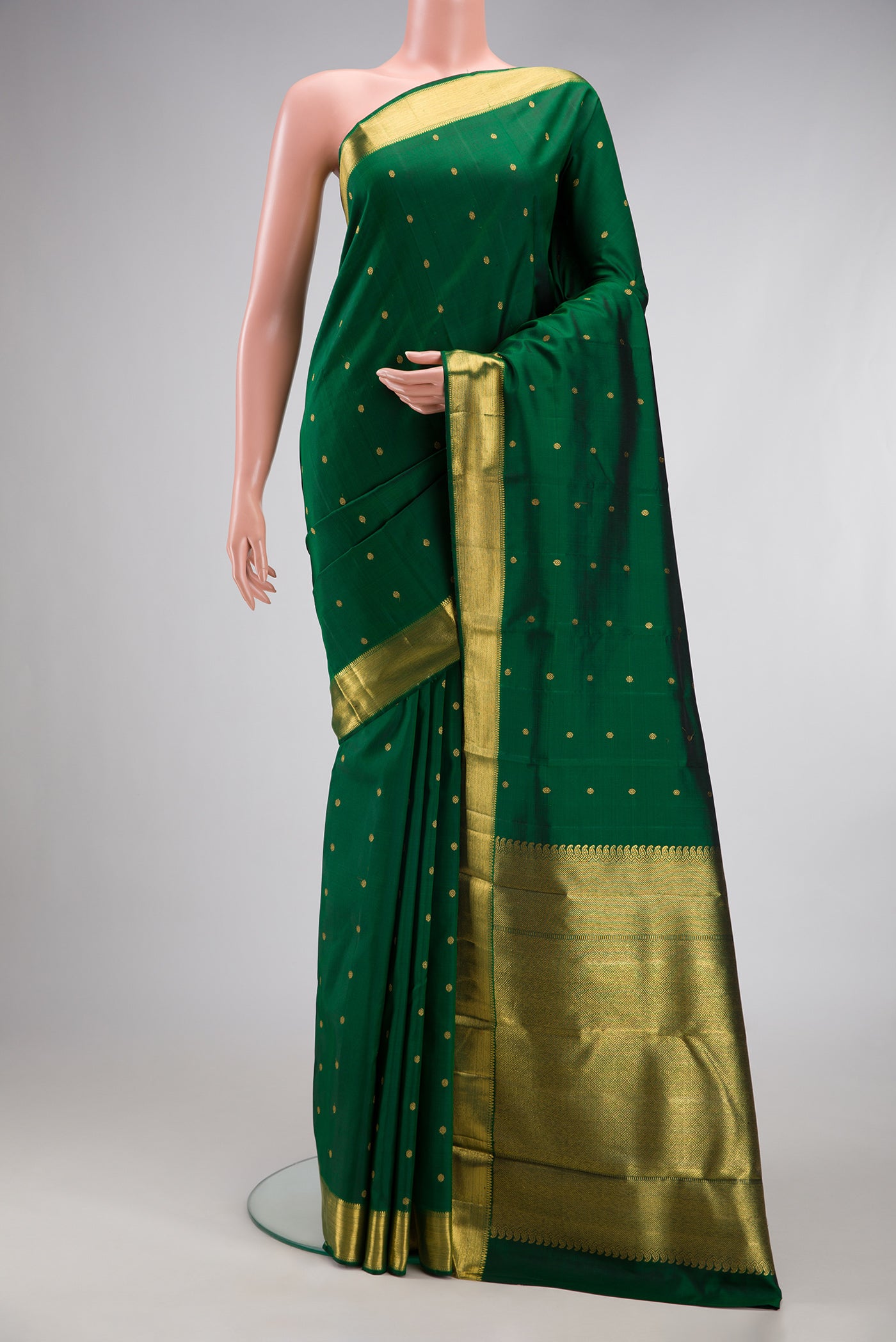 Pure Silk Pure Zari Bottle Green Kanjivaram Saree with Zari Butta on the body and Zari Border.  displayed on a mannequin