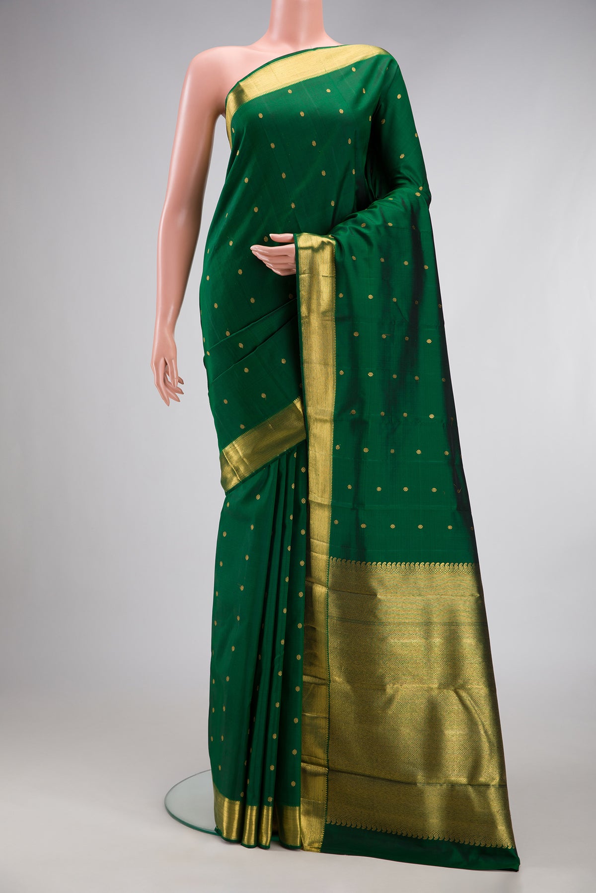 Pure Silk Pure Zari Bottle Green Kanjivaram Saree with Zari Butta on the body and Zari Border.  displayed on a mannequin