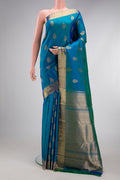 Pure Silk Pure Zari Peacock Blue Dual Tone Kanjivaram Saree with Zari Butta on the body and Zari Border.  displayed on a mannequin