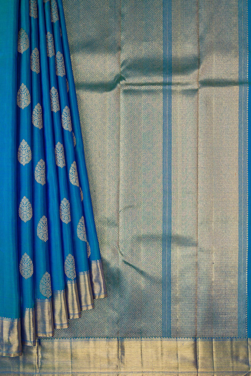 Pleats and pallu of Pure Silk Pure Zari Peacock Blue Dual Tone Kanjivaram Saree with Zari Butta on the body and Zari Border. 