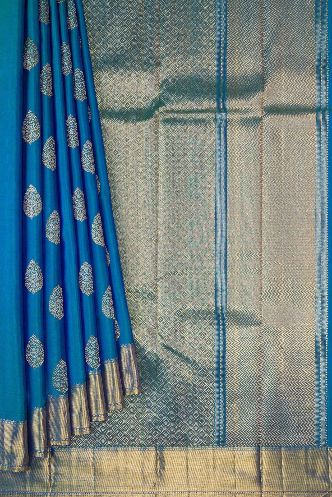 Pleats and pallu of Pure Silk Pure Zari Peacock Blue Dual Tone Kanjivaram Saree with Zari Butta on the body and Zari Border. 