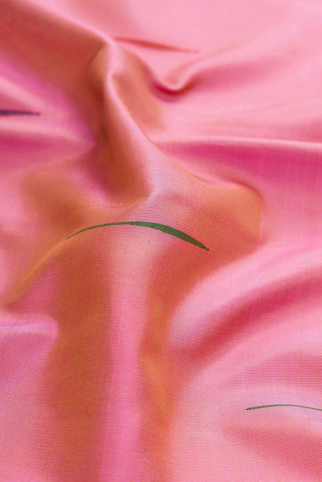 Close up of Pink Dual Tone Kanchipuram Silk Saree with Zari Butta on the body and Temple Border displaying folds