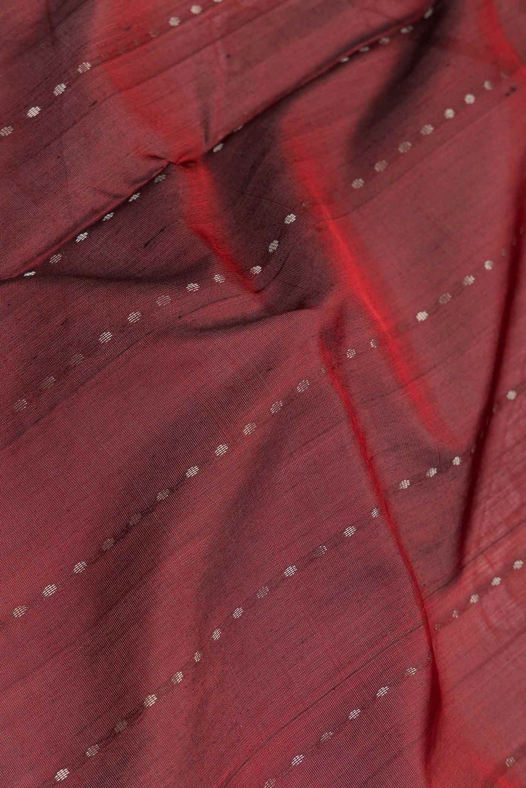 Close up of Maroon Dual Tone Uppada Silk Saree with Zari Butta on the body and Zari Border.  displaying folds