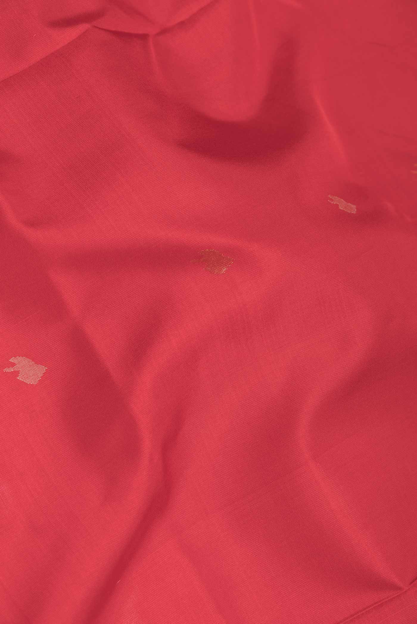 Close up of Red Dual Tone Uppada Silk Saree with Zari And Thread Butta on the body and Zari Border displaying folds