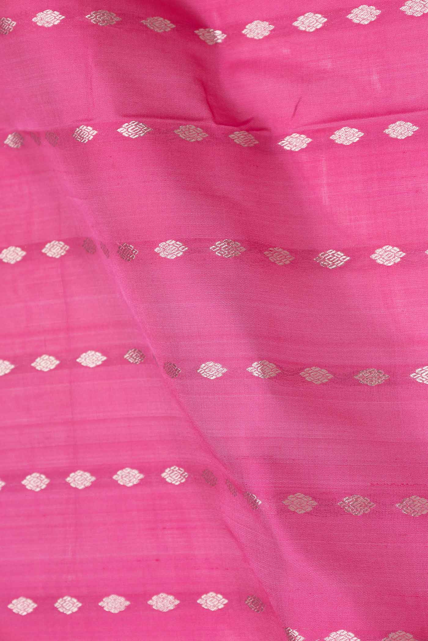 Close up of Pink Dual Tone Uppada Silk Saree with Zari And Thread Butta on the body and Zari Border displaying folds