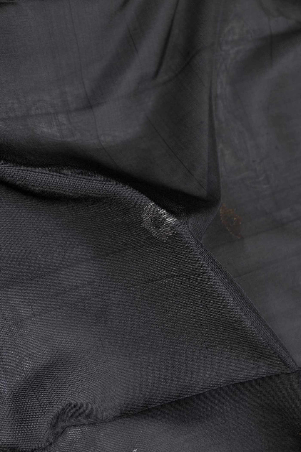 Close up of Black Dual Tone Uppada Silk Saree with Zari Butta on the body and Zari Border displaying folds