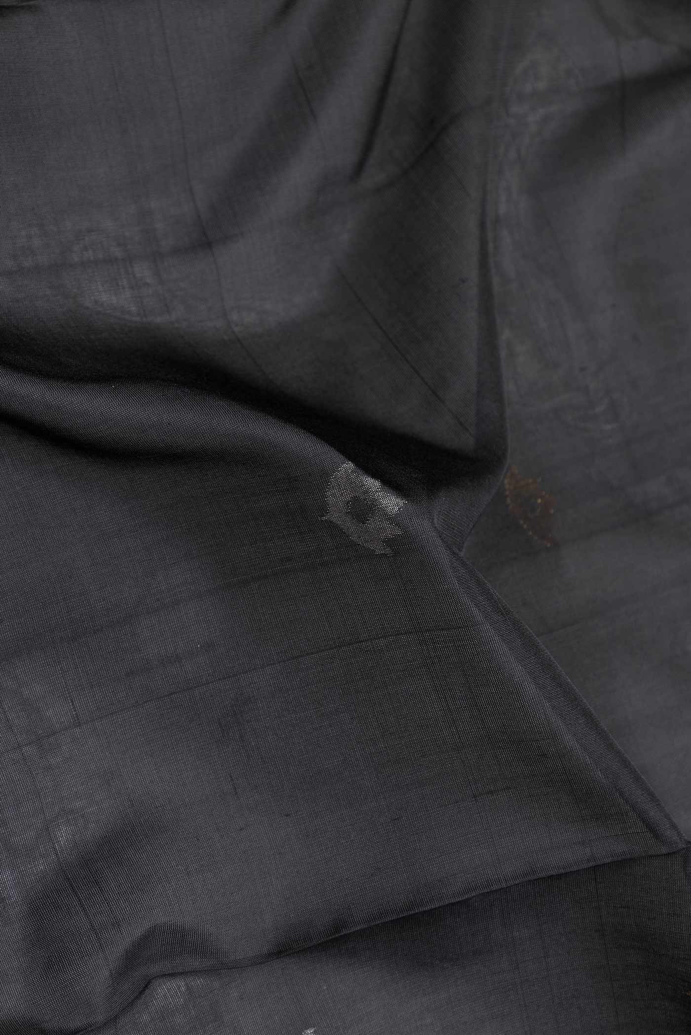Close up of Black Dual Tone Uppada Silk Saree with Zari Butta on the body and Zari Border displaying folds