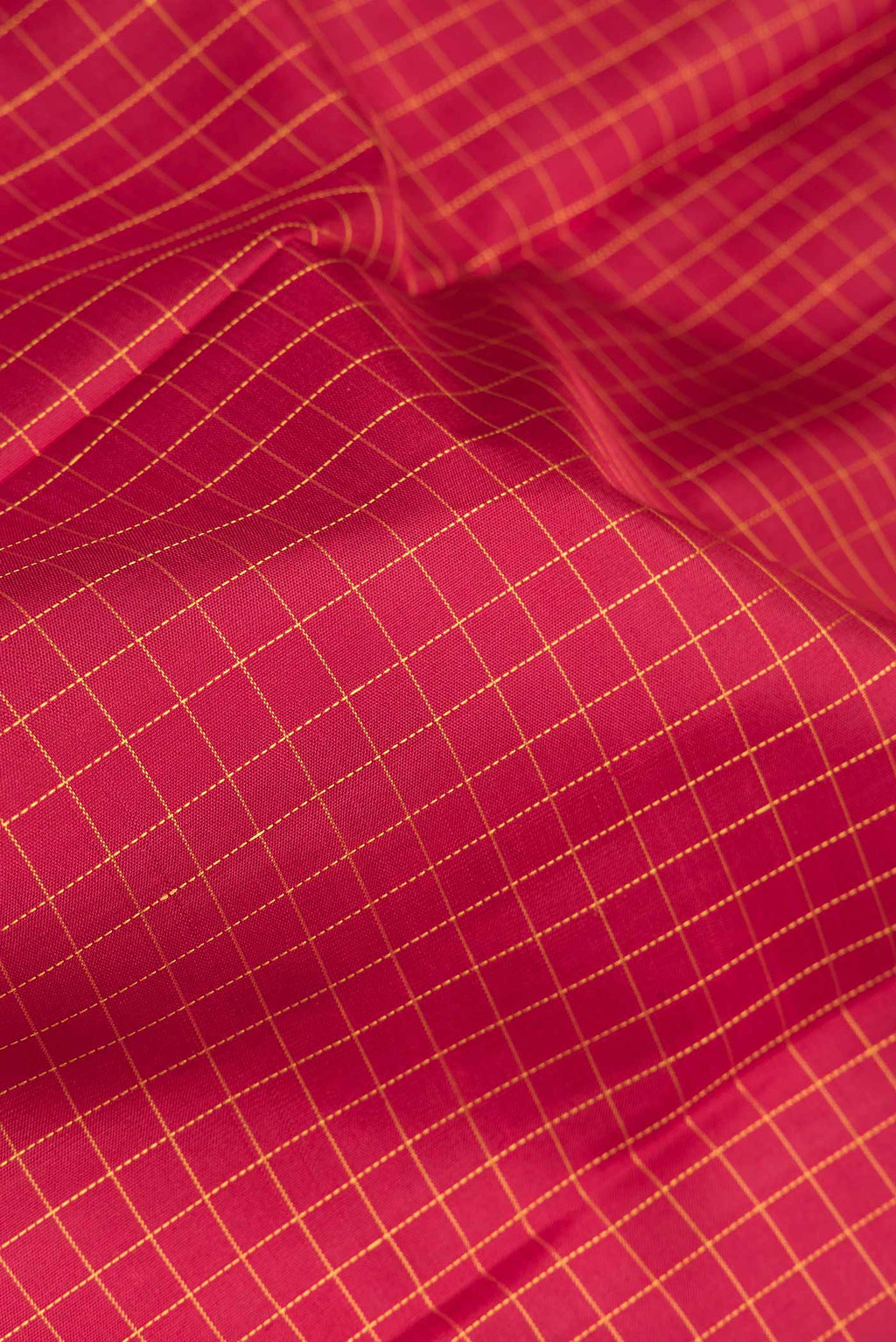 Close up of Maroon Dual Tone Kanchipuram Silk Saree with Checked design on the body and Zari Border.  displaying folds