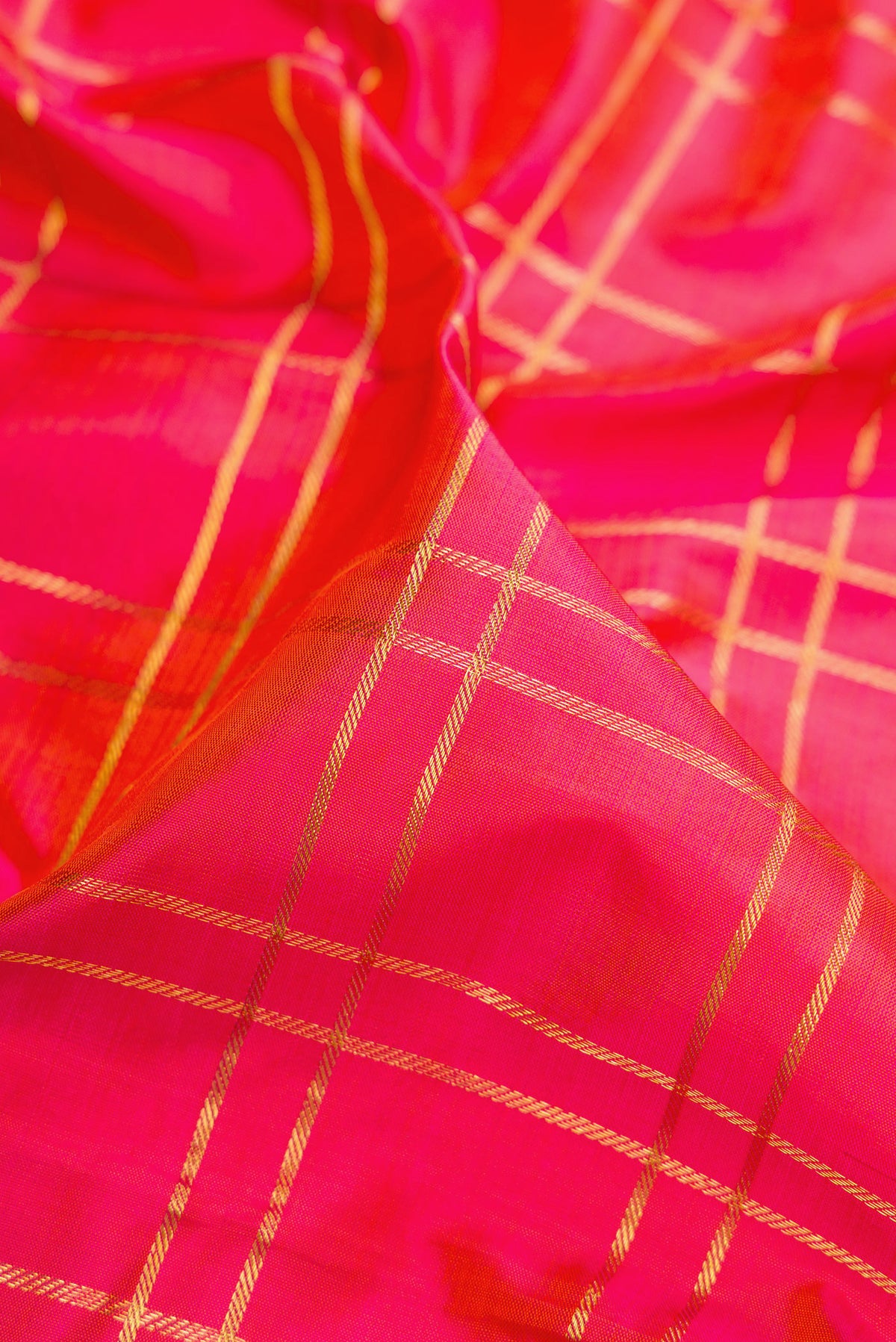 Close up of Pink Kanchipuram Silk Nine Yards Saree with Checked design on the body and Zari Border.  displaying folds