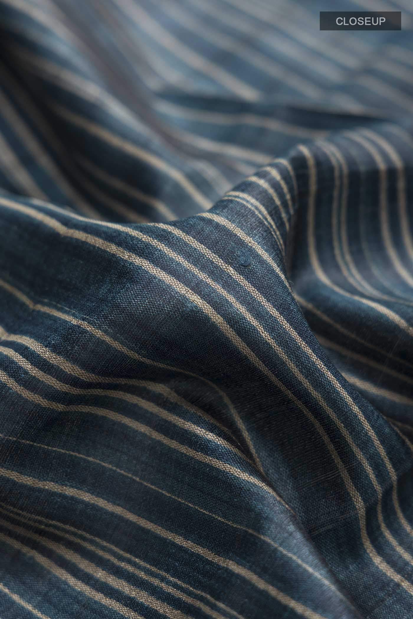 Close up of Blue Tussar Silk Saree with Stripes on the body and Zari Border displaying folds