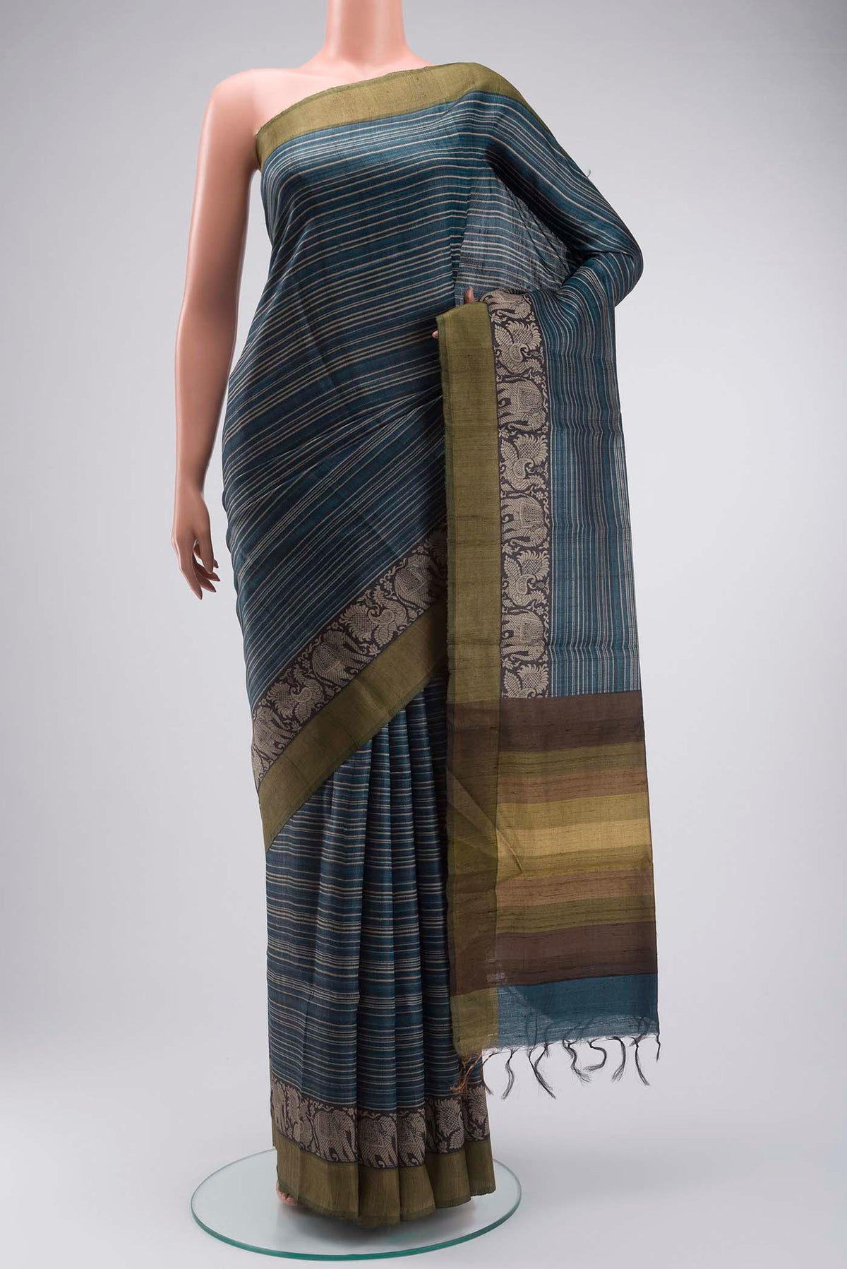 Blue Tussar Silk Saree with Stripes on the body and Zari Border displayed on a mannequin