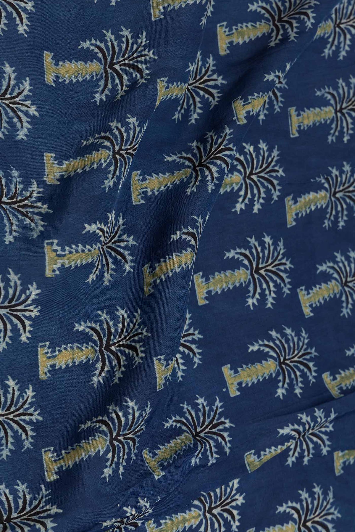 Close up of Navy Blue Dual Tone Satin Silk Saree with Printed design on the body and Zari Border displaying folds