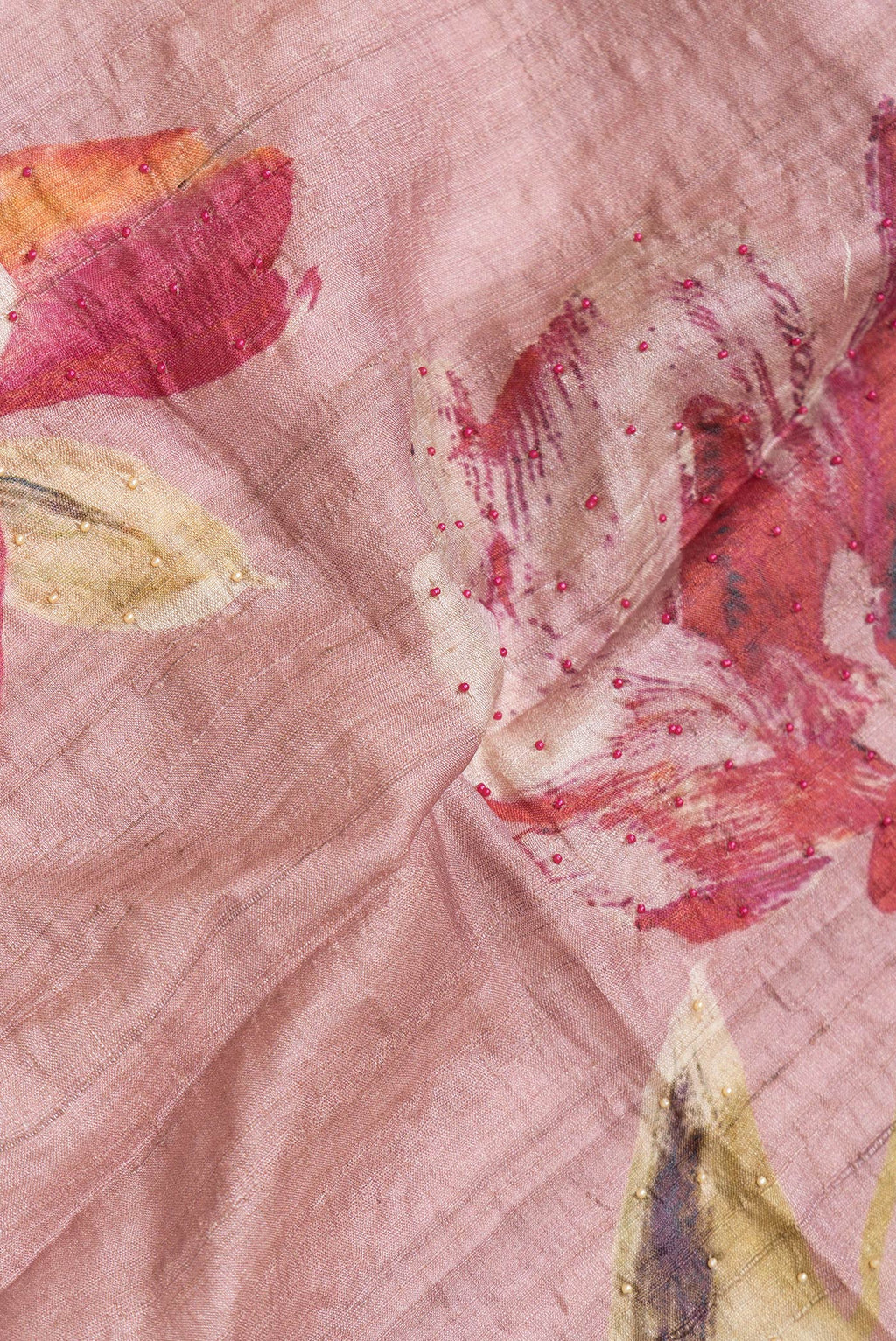 Close up of Rose Gold Dual Tone Tussar Silk Saree with Embroidery on the body and Embroidery Border.  displaying folds