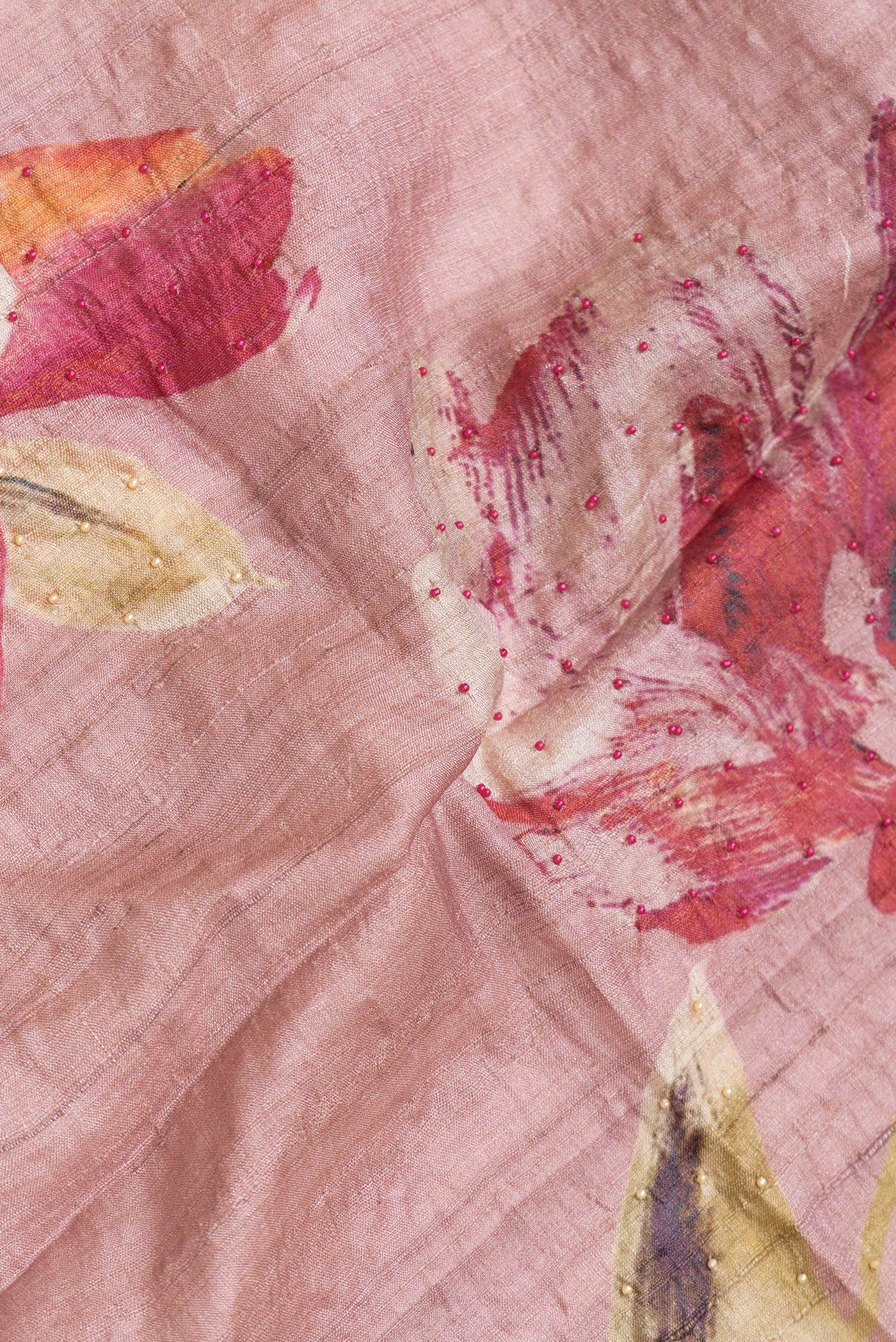 Close up of Rose Gold Dual Tone Tussar Silk Saree with Embroidery on the body and Embroidery Border.  displaying folds