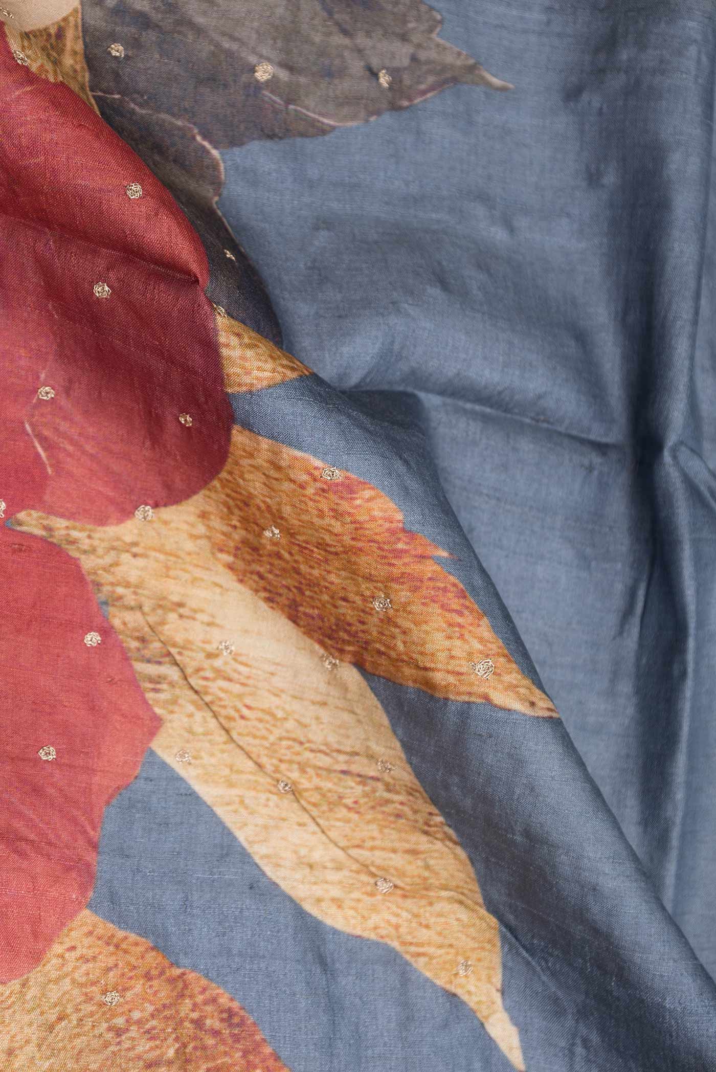 Close up of Blue Grey Tussar Silk Saree with Embroidery on the body and Embroidery Border displaying folds