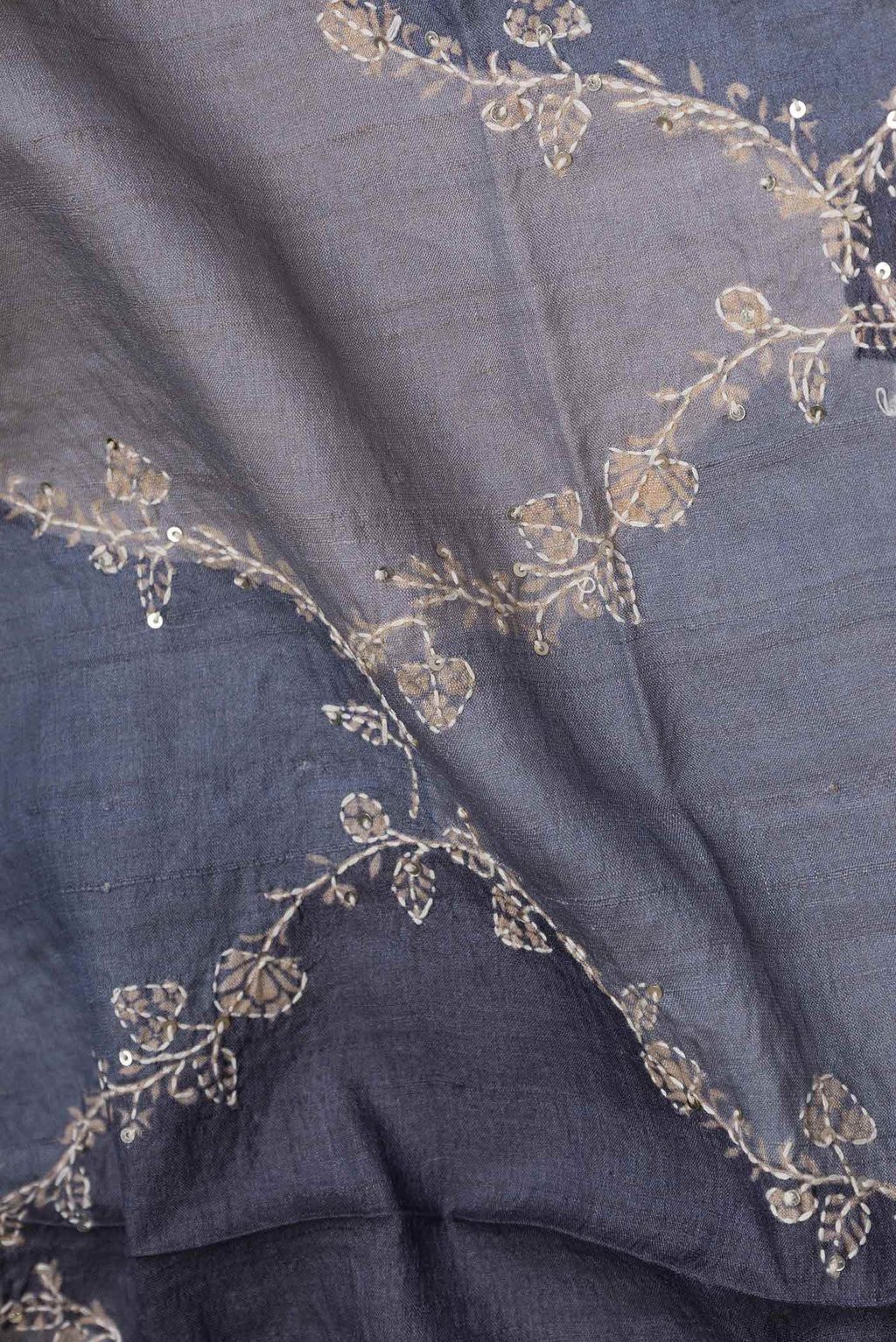 Close up of Grey Dual Tone Tussar Saree with Embroidery on the body and Embroidery Border displaying folds