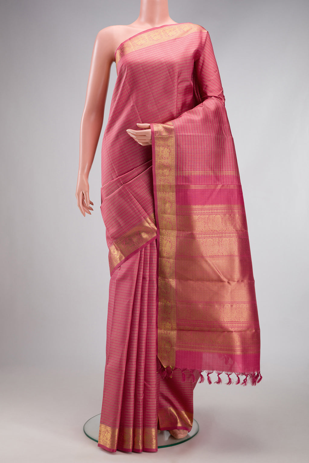 Pure Silk Pure Zari Pink Kanchipuram Saree with Checked design on the body and Zari Border.  displayed on a mannequin