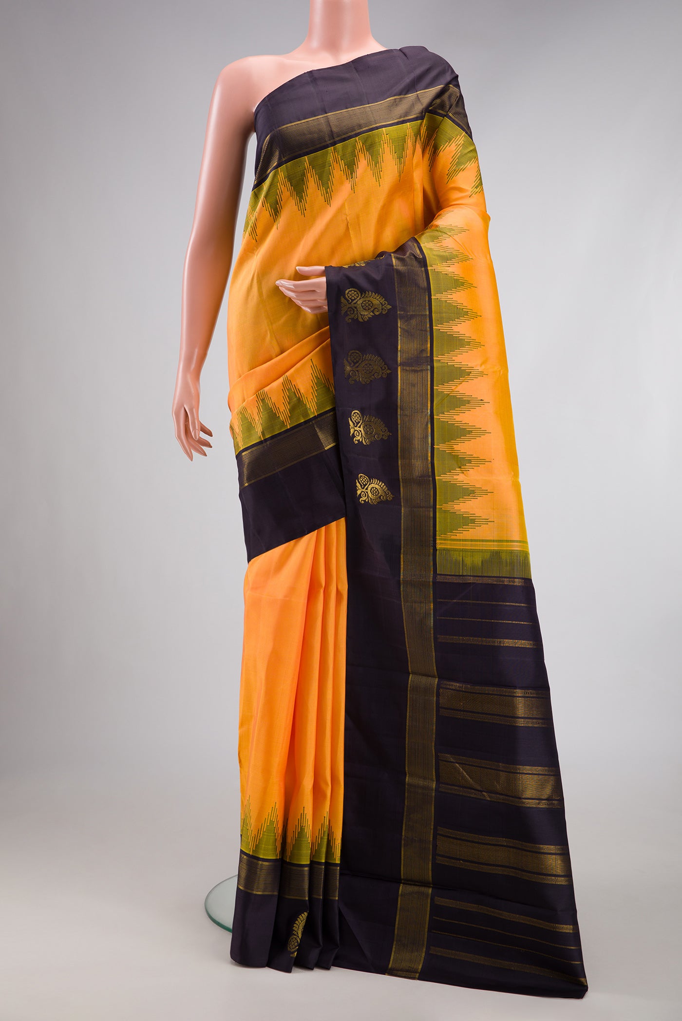 Orange Kanjivaram Silk Saree with Plain Body and Temple Border.  displayed on a mannequin