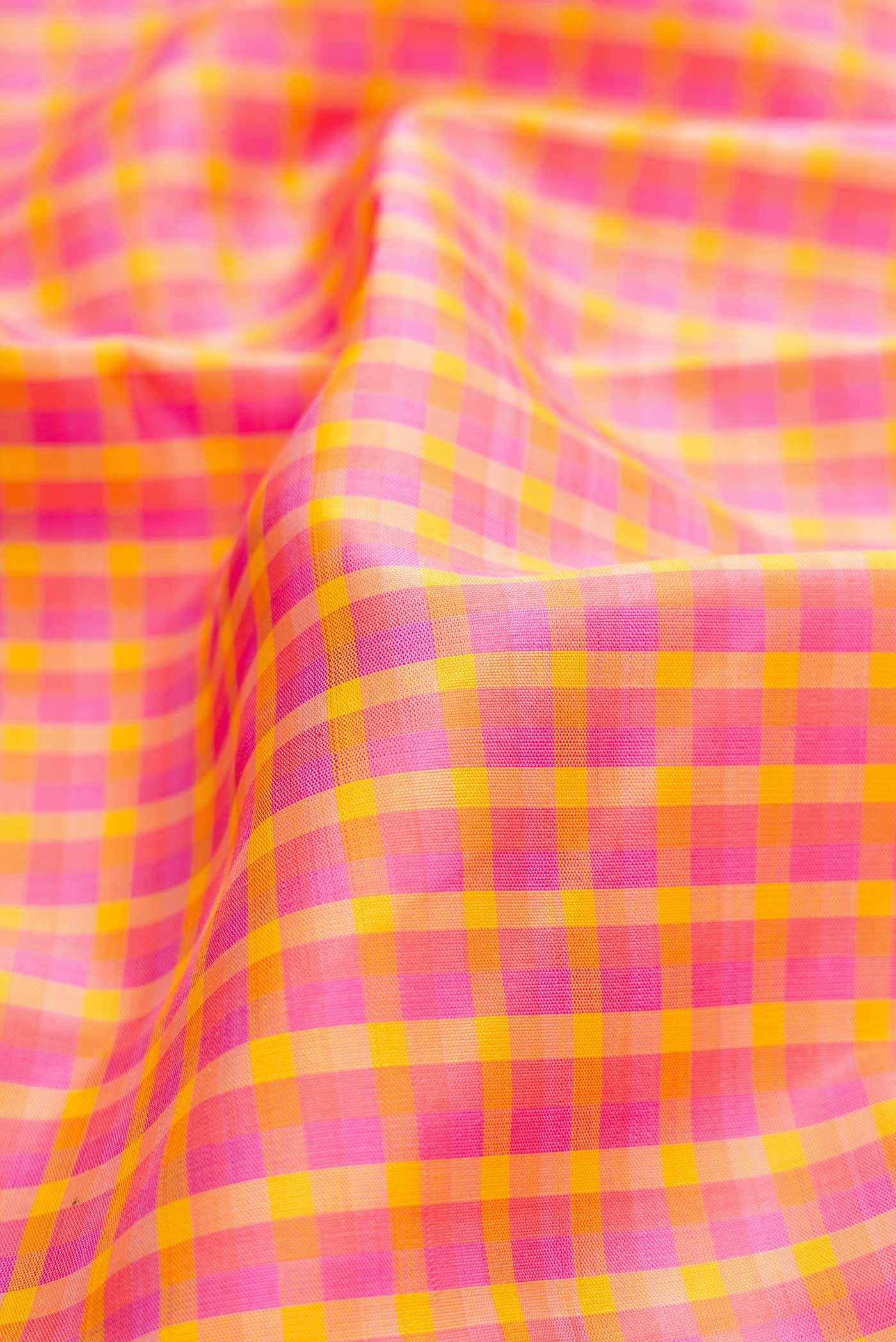Close up of Pure Silk Pure Zari Pink, Purple and Yellow Color Kanchipuram Saree with Checked design on the body and Zari Border displaying folds